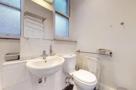 A compact and clean bathroom featuring a white ...
