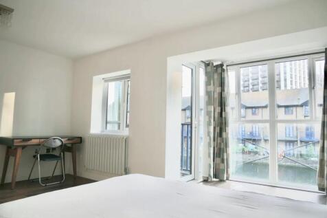 Bright and spacious master bedroom featuring la...