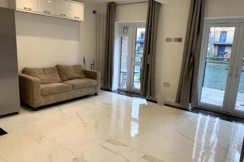 Bright and modern living room featuring glossy ...