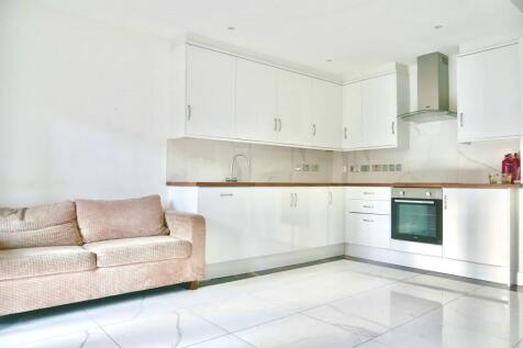 Bright and modern kitchen featuring sleek white...