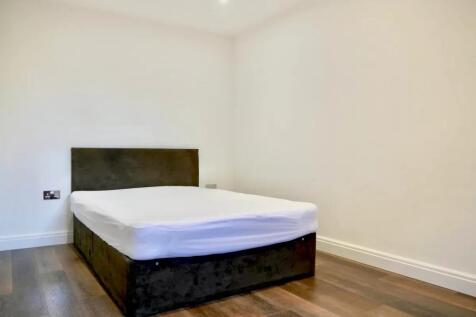A clean and modern double bedroom featuring a d...