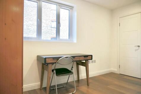 A bright and neat communal workspace featuring ...