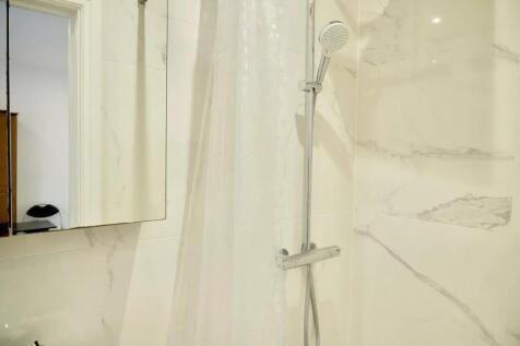 Bright and modern bathroom featuring sleek marb...