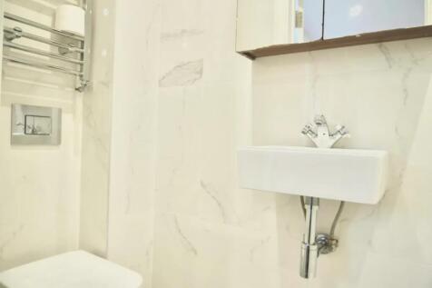 Bright and pristine single toilet with modern f...