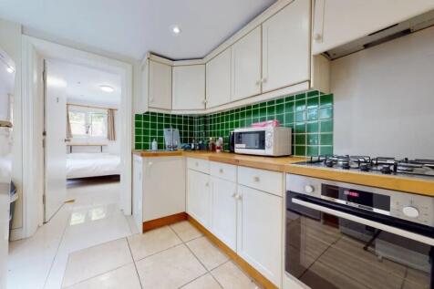 Bright and tidy kitchen featuring modern applia...