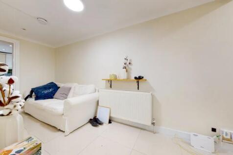 A cozy living room featuring a white sofa again...
