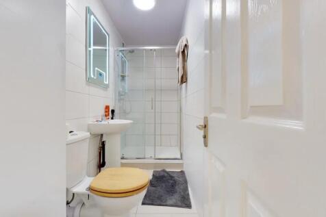 Bright and clean bathroom featuring a modern sh...