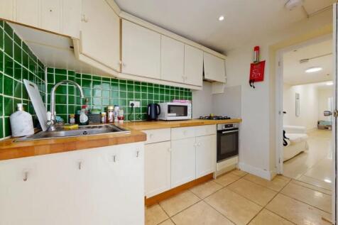 A bright and clean kitchen space featuring clas...