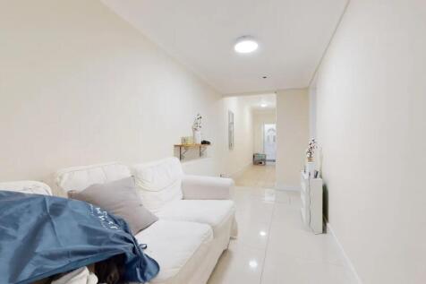 Bright and clean hallway featuring glossy tiled...
