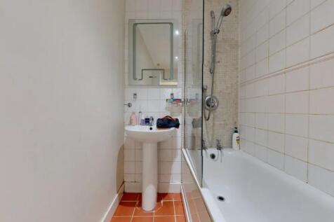 A clean and functional bathroom featuring a whi...