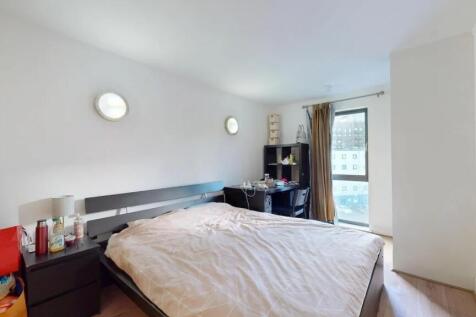Bright and airy master bedroom featuring a larg...
