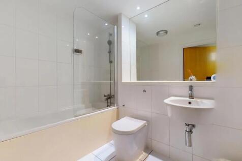 Bright and modern bathroom suite featuring a cl...