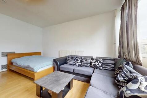 A bright and inviting master bedroom featuring ...