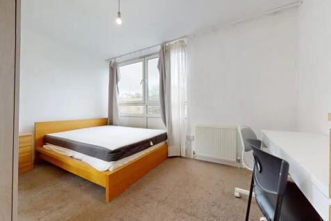 Bright and airy master bedroom featuring a larg...