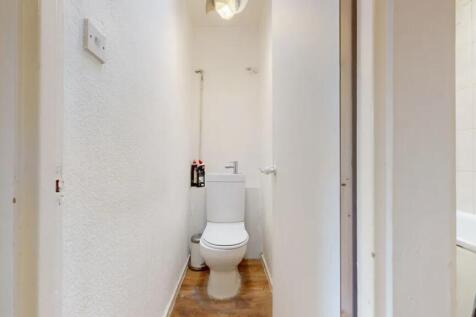 A compact and clean single toilet room with a m...
