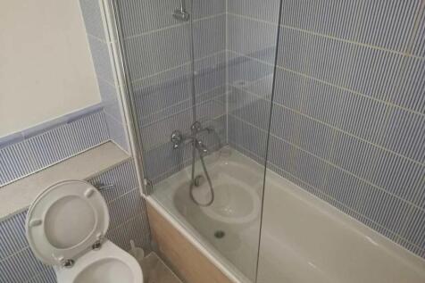 A clean and functional bathroom suite featuring...