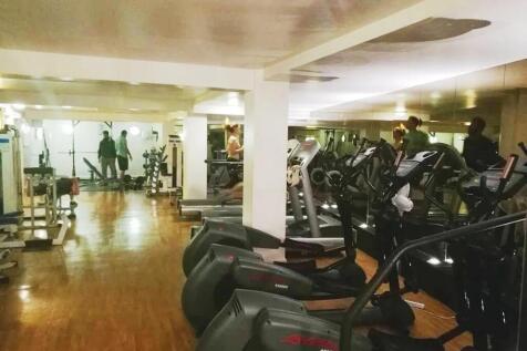 A spacious gym room featuring a variety of card...