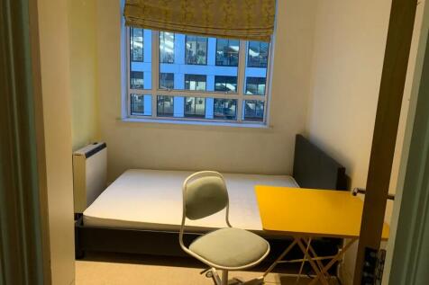 A neat and simple single bedroom featuring a co...