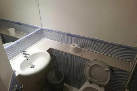 Compact and functional bathroom featuring a cle...