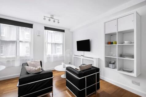 Bright and modern living room featuring sleek b...