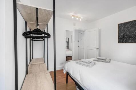 A clean and modern double bedroom featuring a n...