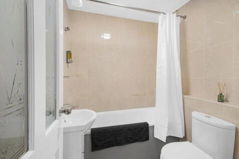 A clean and modern bathroom suite featuring bei...