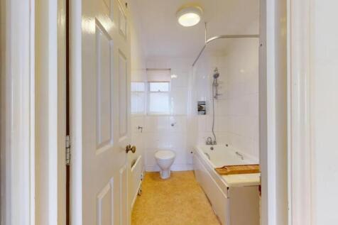 A bright and clean bathroom featuring a full-si...