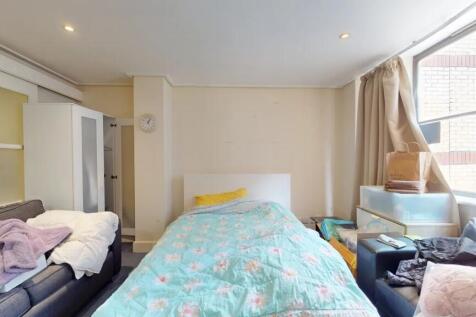 Cozy single bedroom featuring a comfortable bed...