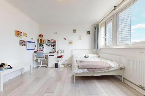 Bright and airy master bedroom featuring a comf...