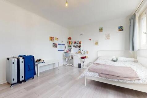 A bright, tidy double bedroom featuring a white...