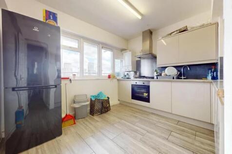 Bright, modern kitchen featuring sleek cabinetr...