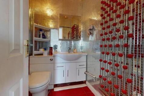 Bright and modern bathroom featuring reflective...