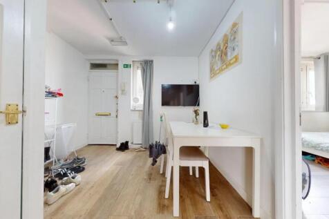 Bright and tidy hallway with wood-effect floori...