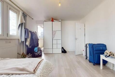 A bright, clean single bedroom featuring light ...