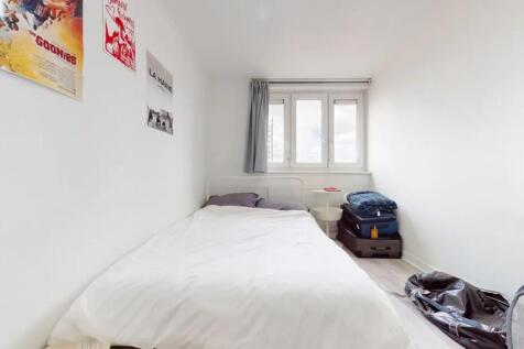 A bright, tidy single bedroom with a white bed ...