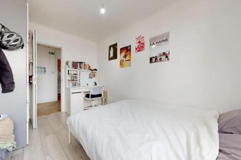 Bright and tidy single bedroom featuring a cozy...