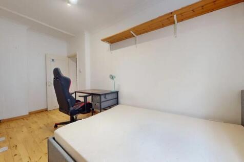 Bright and tidy double bedroom featuring wooden...