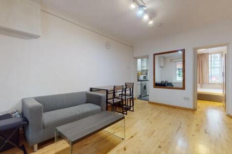 A bright and tidy living room featuring a moder...