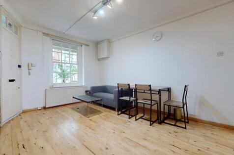 A bright and tidy living room featuring a large...