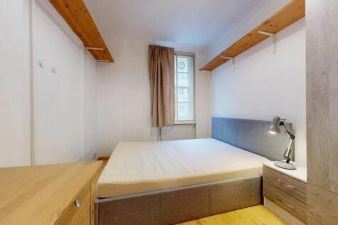 Bright and neatly arranged double bedroom featu...