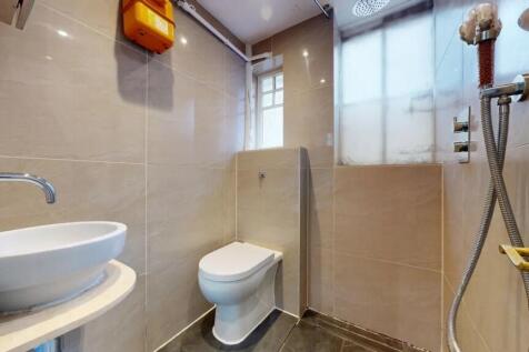 A clean and modern single toilet room featuring...