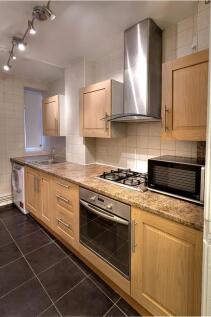 Bright and modern kitchen featuring sleek woode...