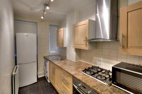 A well-maintained kitchen featuring wooden cabi...