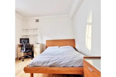 Bright and tidy double bedroom featuring a comf...