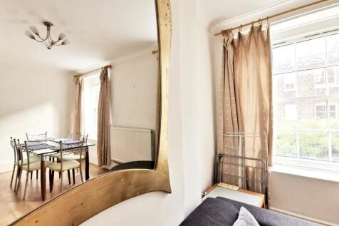 Bright and airy living room featuring a large w...