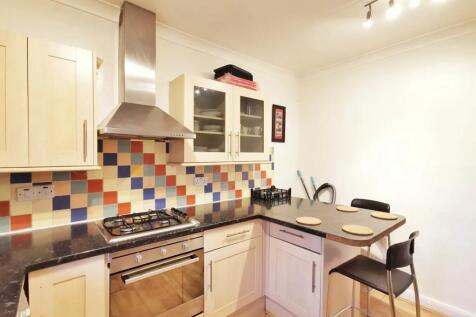 A bright and modern kitchen featuring a stylish...