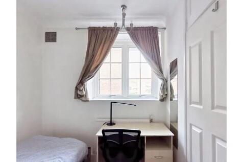 Bright and tidy single bedroom featuring a wind...