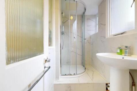 Bright and clean bathroom featuring a modern cu...