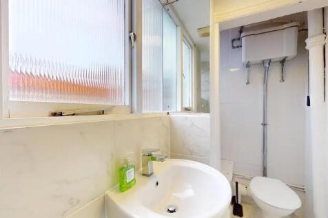 Bright and clean single toilet featuring a mode...