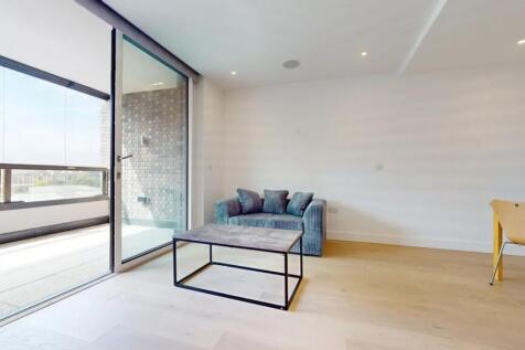 A modern living room with a sleek blue sofa and...